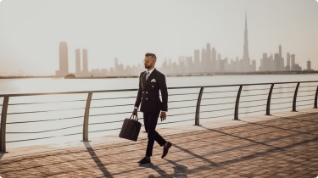 a man in black suit carrying a suitcase